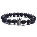 Lava stone bead bracelet with a silver crown charm and metal accents on white backdrop - Lava Rock Silver Crown