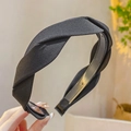 Detail of a wide black braided headband with soft fabric texture and twisted design knot - Black