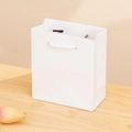 Vertical white paper gift bag with handles on wooden desk for jewelry storage - White Gift Bag / 12*13.5*6cm