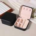 Portable black PU leather jewelry box with zipper closure and soft beige interior lining - Black