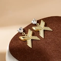 Golden bow-knot drop earrings featuring a heart-shaped zircon on a brown felt surface - Heart-Shaped Zirconia Bow Pendant (E5155)