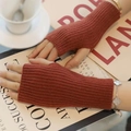 Thick brick red knit fingerless gloves with thumb hole on a lifestyle background - One Size / Brick Red