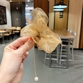 Close-up of golden organza bow hair claw with elegant pearl tassel pendant detail - Bow Claw Clip / Champagne