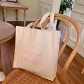 Cream canvas tote bag with pink gradient beloved embroidery on vintage chair - Pink Gradient Embroidery