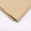 Close-up of brown tissue paper stack showing fine natural texture and clean edges - Light Coffee