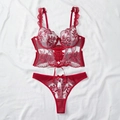 Flat lay of red lace lingerie set with corset-style underwire bra and floral thong - Burgundy