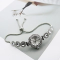 Women's quartz bracelet watch with floral rhinestone bezel and adjustable pull chain - Silver White