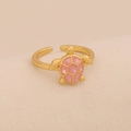 Detailed close-up of a golden turtle ring with a pink geometric shell on beige fabric - Pink Sea Turtle Open Ring (7#Pink)