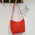 Quilted red shoulder bag for women with golden flower clasp and slim strap design - Red
