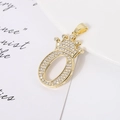 Macro shot of gold-plated crown number zero pendant with sparkling clear zircons - Letter O
