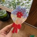 Eleganter Haarklammer mit blauen und roten Kristallblumen und einer charmanten roten Schleife - Rote Schleife Blumenstrauß