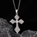 Macro shot of a silver cross pendant with sparkling white cubic zirconia on black rock - Style 28: Brass Plated With Real Gold + Stainless Steel Chain (color Retention)