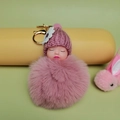 Cute sleeping baby doll keychain with dusty pink pompom and white flower knit hat - Dusty Pink