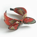 Vintage red paisley bow headband with wide fabric knot design for women on white background - Red Scarf Print Bow