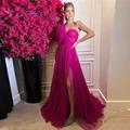 Detail of fuchsia corset evening gown with mesh draping and high leg slit feature - Rose Red