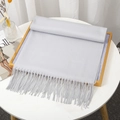 Solid light grey cashmere-like scarf featuring elegant tassels on a golden tray - Light Gray