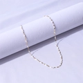 Dettaglio di una catena sottile dorata con perle oliva in smalto bianco da donna - Oro+Bianco / 40+5cm