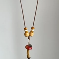 Creative mushroom pendant necklace with red wood beads and natural forest style aesthetic - Brown