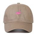 Close-up of pink flamingo embroidery on a beige cotton twill baseball cap - Khaki