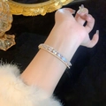 Elegant gold plated bangle with sparkling pavé cubic zirconia on female wrist - Gold Teardrop Zirconia Bangle (A2145)