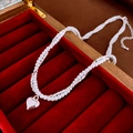 Detail of double-layer pearl necklace with a polished silver heart pendant on red velvet - Double-Layer Heart Pendant / Silver-White