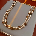 Detail of double-layer necklace with white pearls and brown tiger eye stone beads - Champagne