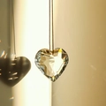 Heart-shaped crystal suncatcher pendant with brown cord and colorful light reflections - 30MM / Clear