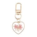Detail of a heart-shaped resin keychain featuring preserved pink dried flowers - Heart Pink Flower