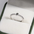 Detail of silver brass ring with letter F and diamonds in a green velvet box - Platinum F