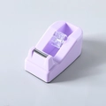 Close-up of purple tape dispenser with metal serrated blade on a clean grey background - Purple