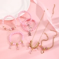 Detailed view of pink ribbon breast cancer awareness jewelry set with HOPE charm and pearls - Pink Ribbon Ultimate Jewelry 5-Piece Set