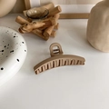 Minimalist matte milk tea hair claw clip on white surface with elegant lifestyle props - Coffee Arc