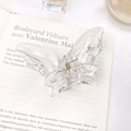 Transparent butterfly hair claw clip with crystal resin finish on aesthetic book background - Large 5.5cm / Clear