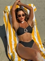 Chic black textured two-piece bikini with a gold metal buckle on a beach towel - S / Black