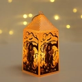 Detail of Halloween pumpkin lantern with grim reaper and bat silhouettes in warm lighting - Skull