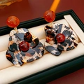 Close-up of leopard print resin flower earrings with red bead in a black jewelry box - Coffee Leopard Print (S925 Silver Pin)