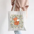 Canvas tote bag with artistic fox and floral illustration carried by a model - Style C1-Fox Floral