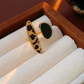 Close-up of golden adjustable ring with leopard print and dark oval enamel inlay - Black Leopard