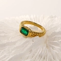 Macro detail of French style 18k gold ring with ribbed texture and emerald-cut green stone - Gold Green Zirconia