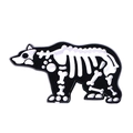 Detailed view of polar bear skeleton enamel pin with black background and white bone details - Skeleton Bear