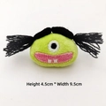 Close-up of green plush monster charm with pigtails and detailed embroidery 4.5x9.5cm - Black Hair Ugly Girl