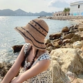 Detail of hand-woven straw hat with black stripes texture against a scenic coastal background - L (58-60cm) / Contrast Trim Stripe Khaki