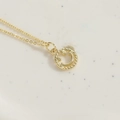 Minimalist gold smiling face pendant necklace with round bead texture on a delicate O-chain - Gold