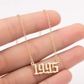 Detail of 1995 birth year pendant in gold plating held to show fine chain texture - 1995 / Gold