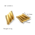 Macro shot of gold wave earrings with side-set cubic zirconia stones and 25mm dimensions - Gold Color with Zircon