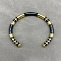 Minimalist C-shaped open bangle featuring stylish black and gold striped metal design - Black