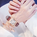 Square rose gold watch with brown leather strap and matching star charm bracelet on wrist - Brown Watch + Bracelet