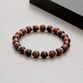 Detail of red tiger eye beads with silver metal spacers on a flexible bracelet - Red Tiger Eye (KB183245-TLX)