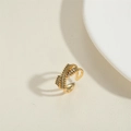 Elegant gold open ring featuring crisscross rows of olive green baguette cut cubic zirconia - Black Zirconia
