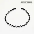 Detail view of a black wavy metal headband with flexible sawtooth structure for hair - Wavy Style 1pc